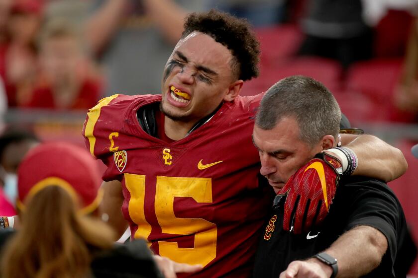 LOS ANGELES, CALIF. - OCT. 30, 2021. USC receiver Drake London winces in pain after suffering an injury.