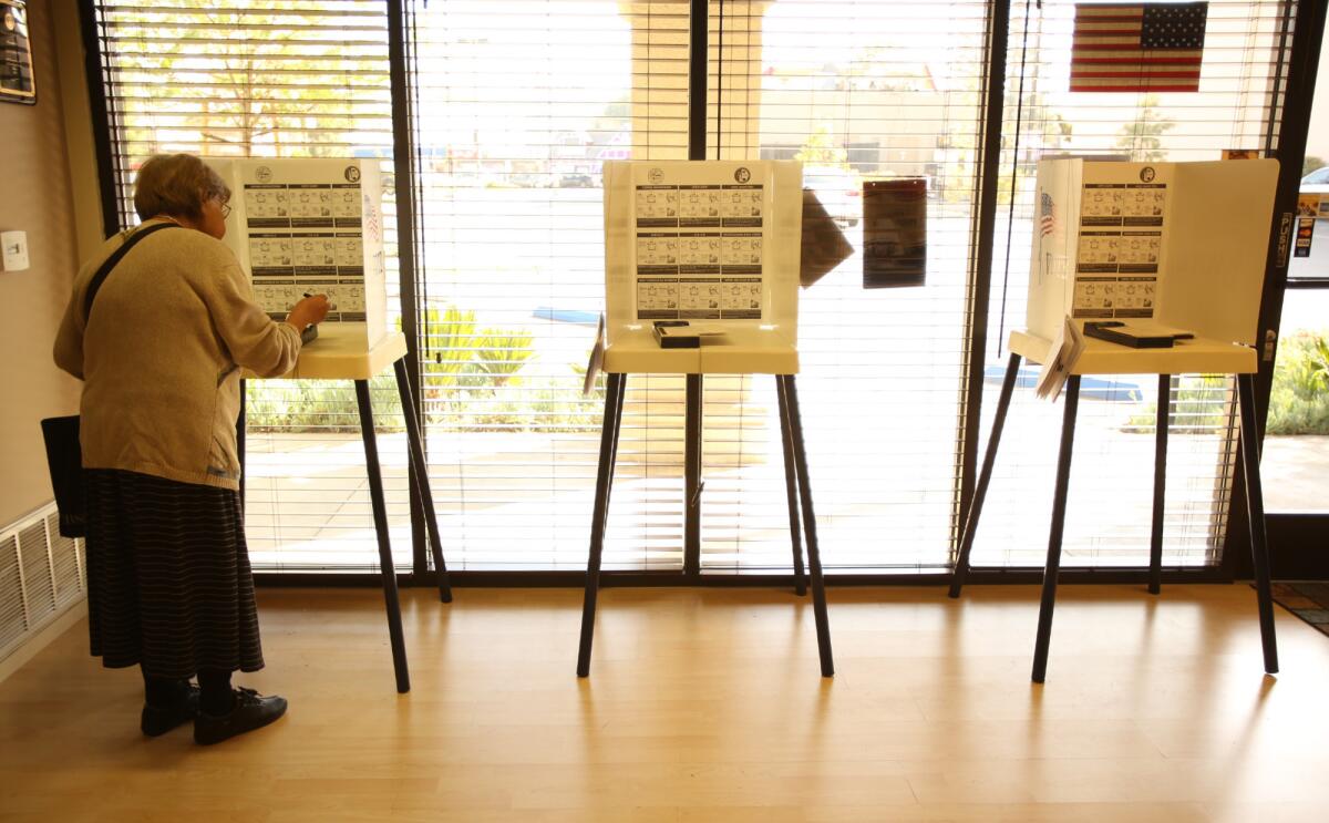 Olga Korn votes in the Los Angeles city election this week. Voters in two of California's senate districts cast ballots next week.