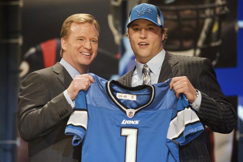 NFL commissioner Roger Goodell poses with Matthew Stafford, the No. 1 pick of the 2099 draft by the Lions.