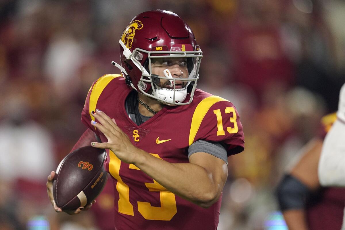 USC quarterback Caleb Williams runs with the ball during a game.