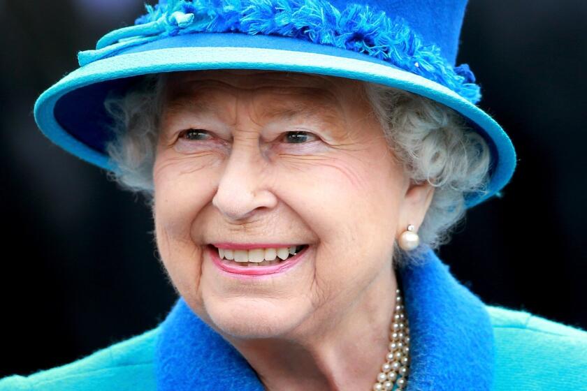 Queen Elizabeth II smiles as she arrives at Tweedbank Station in Tweedbank, Scotland, on Sept. 9, they day she became the longest-reigning monarch in British history.