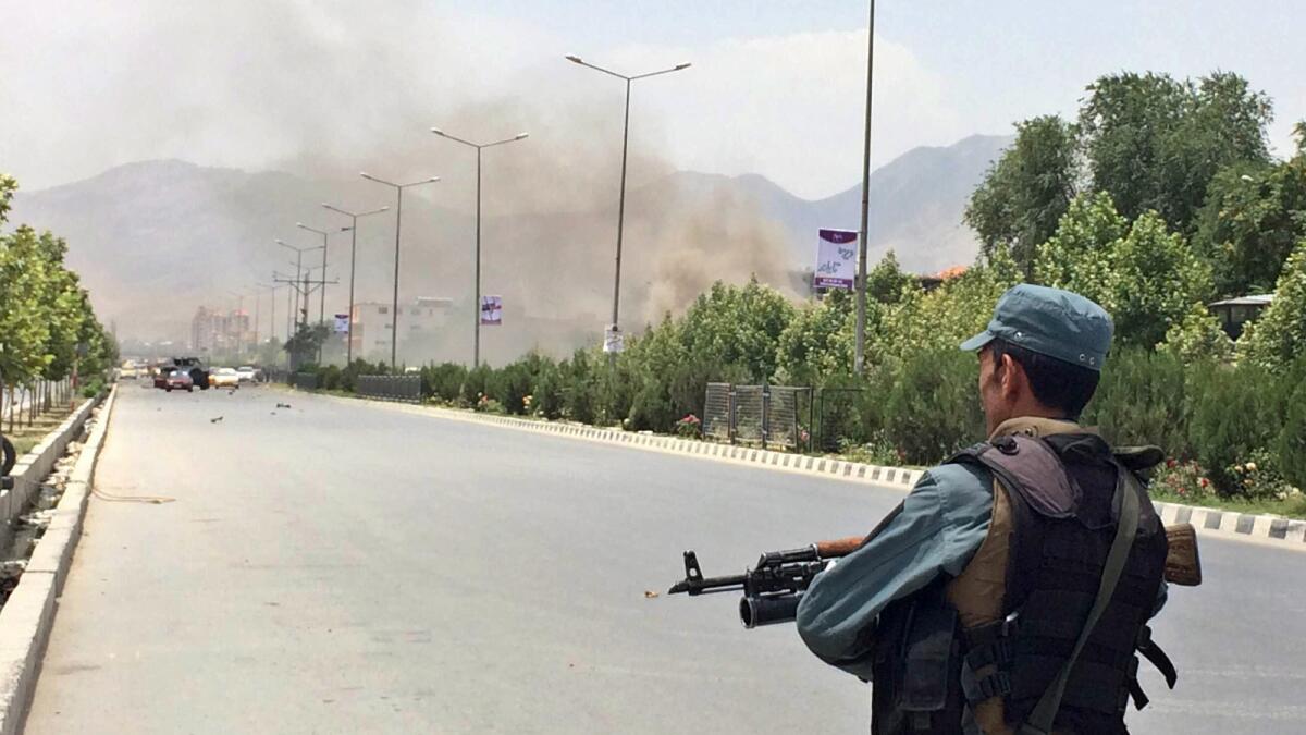 A security officer stands guard outside the Afghan parliament building in Kabul after a Taliban attack on Monday.