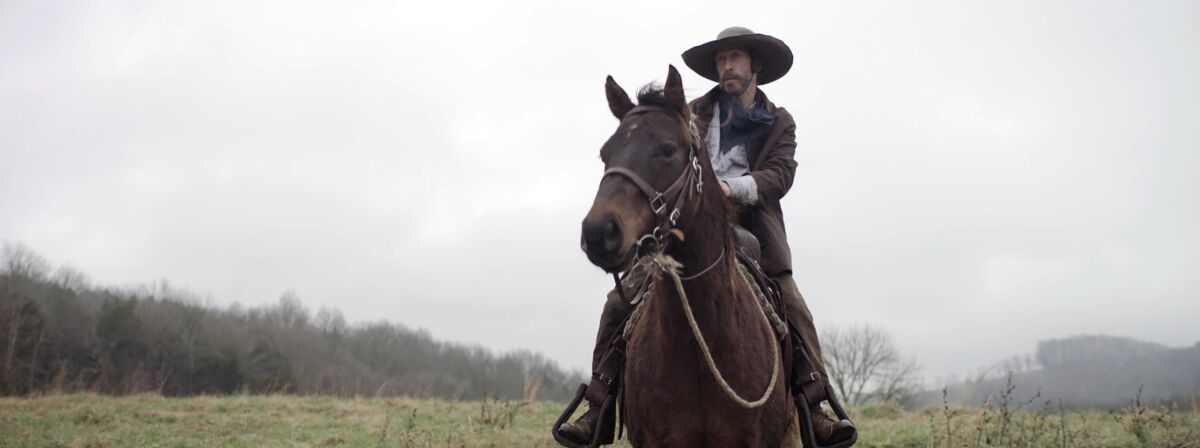 Henry McCarty (played by Tim Blake Nelson) rides a horse in “Old Henry.”