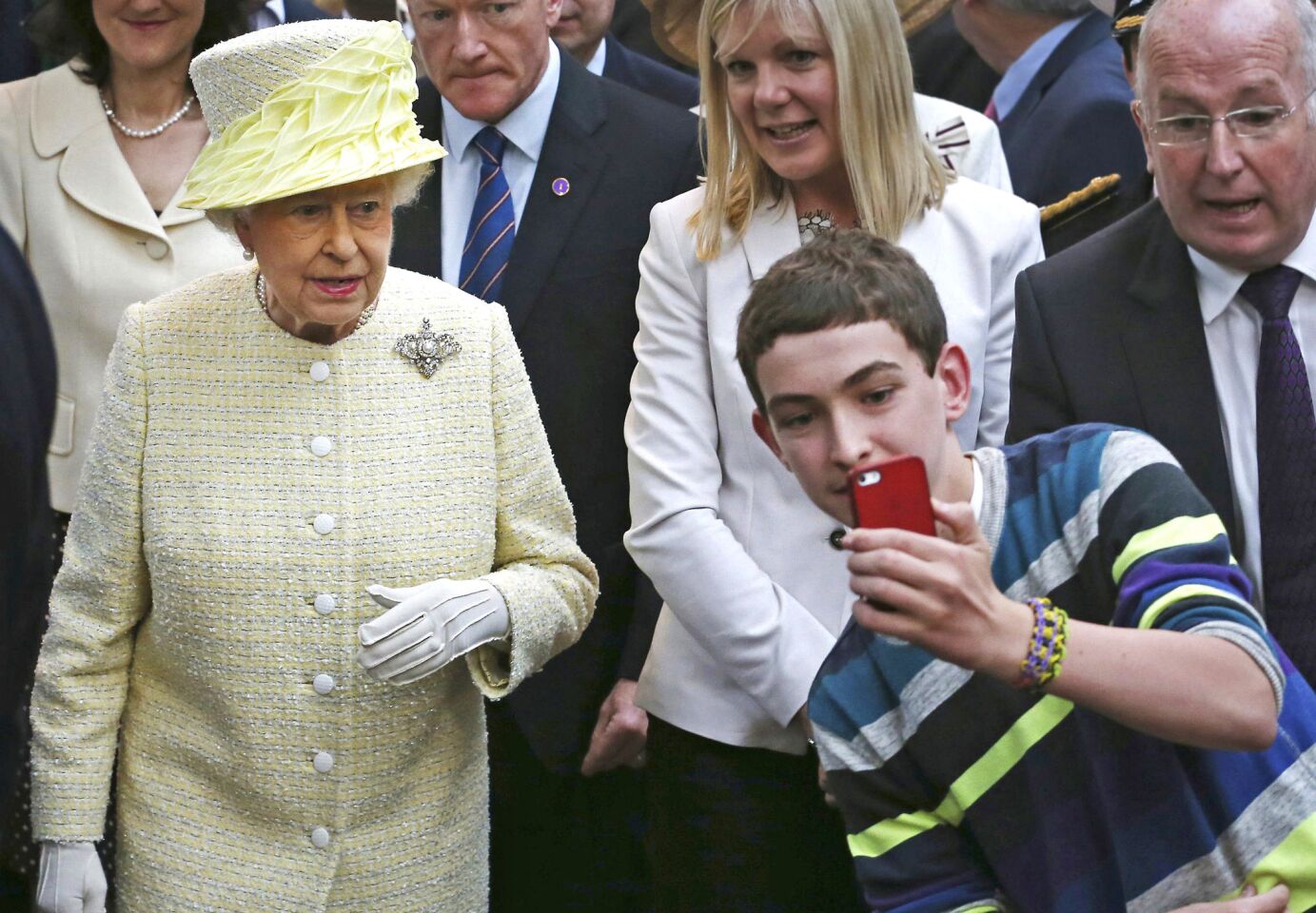 A youth takes a selfie photograph in front of Queen Elizabeth II earlier this year. On Sept. 9, the queen is expected to become the longest-reigning monarch in British history -- more than 63 years on the throne.