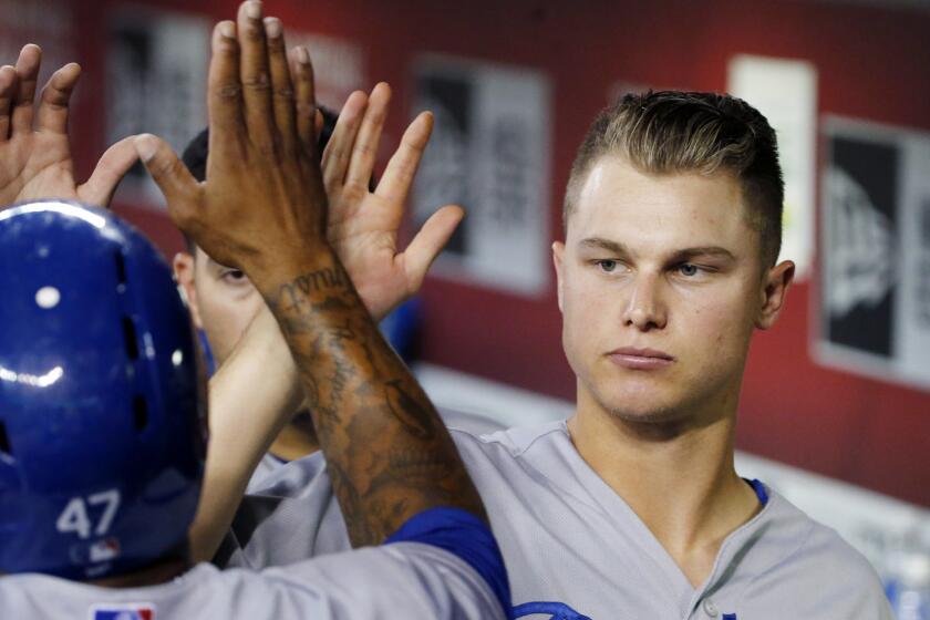 Dodgers center fielder Joc Pederson congratulates second baseman Howie Kendrick for scoring a run during a game against the Arizona Diamondbacks on July 1.