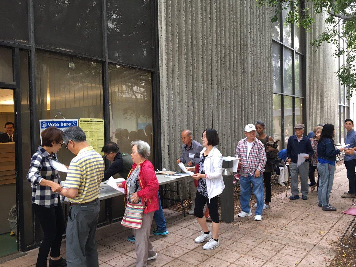 Voters line up for early voting over the weekend at Pio Pico Library in Koreatown