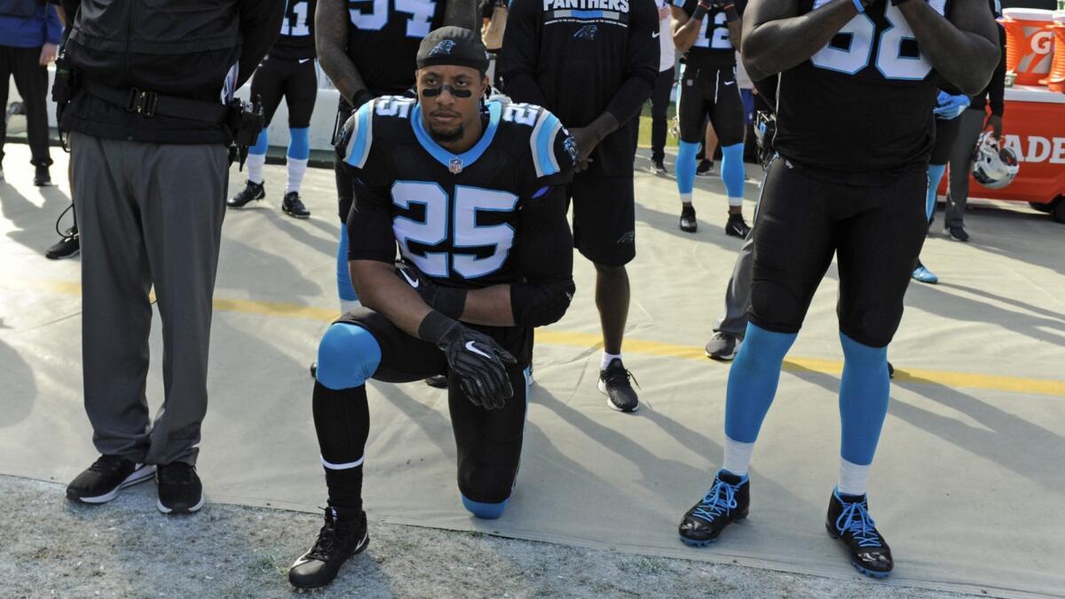 Carolina's Eric Reid kneels during the national anthem before a game against Seattle on Nov. 25.