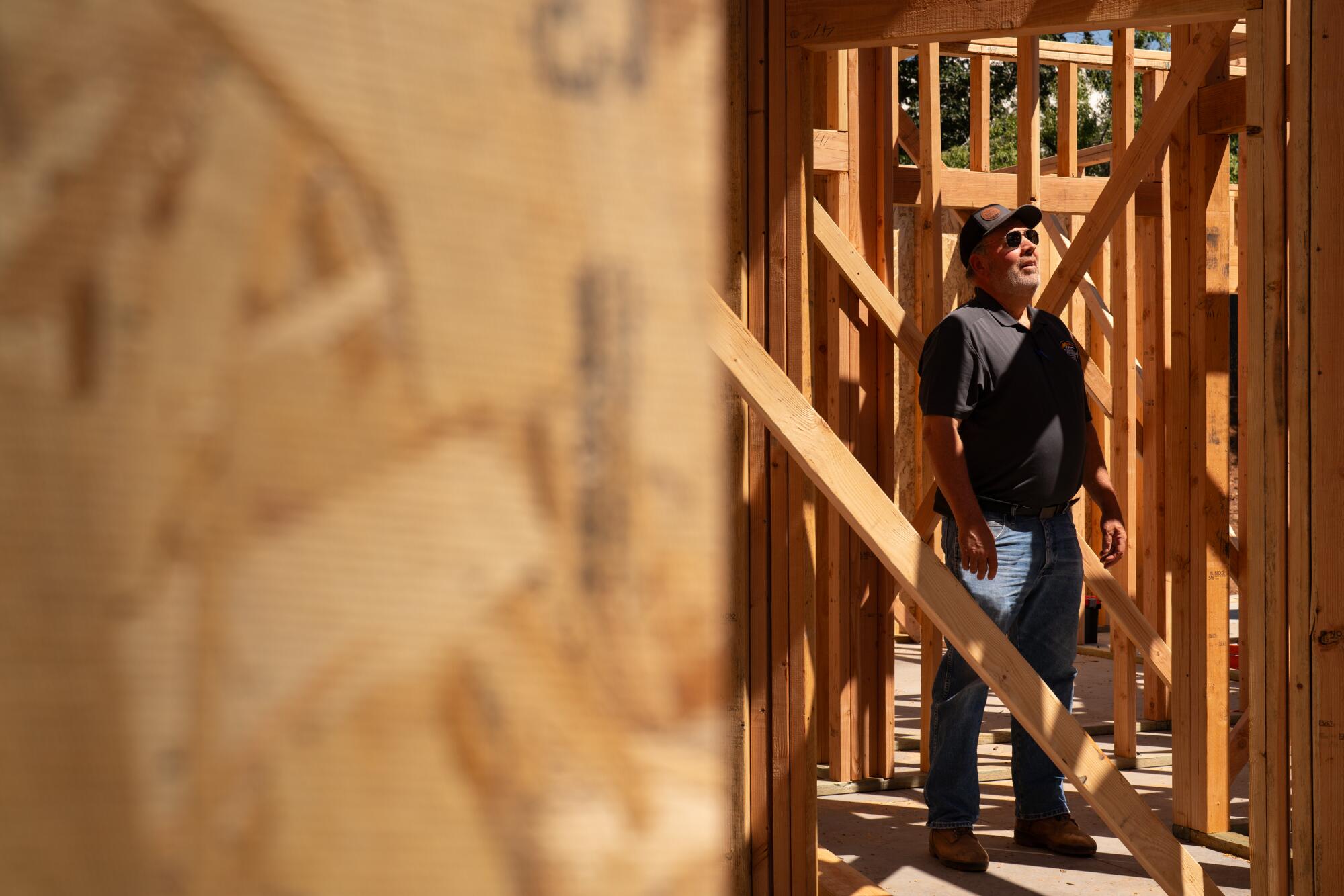A man stands in a home being built. 