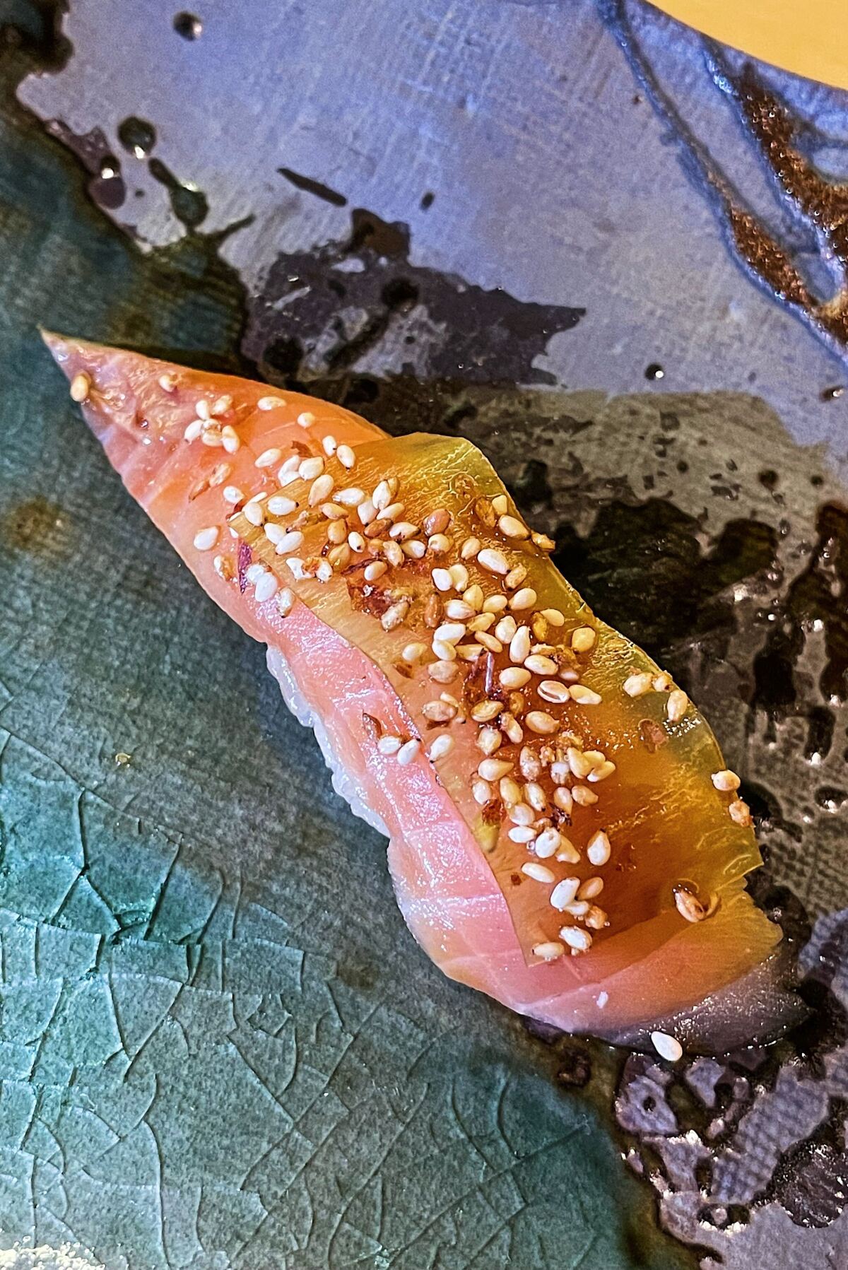 An overhead of sea trout nigiri, its fish draped in kombu and sprinkled with Kyoto sesame seeds at Sushi Sonagi in Gardena
