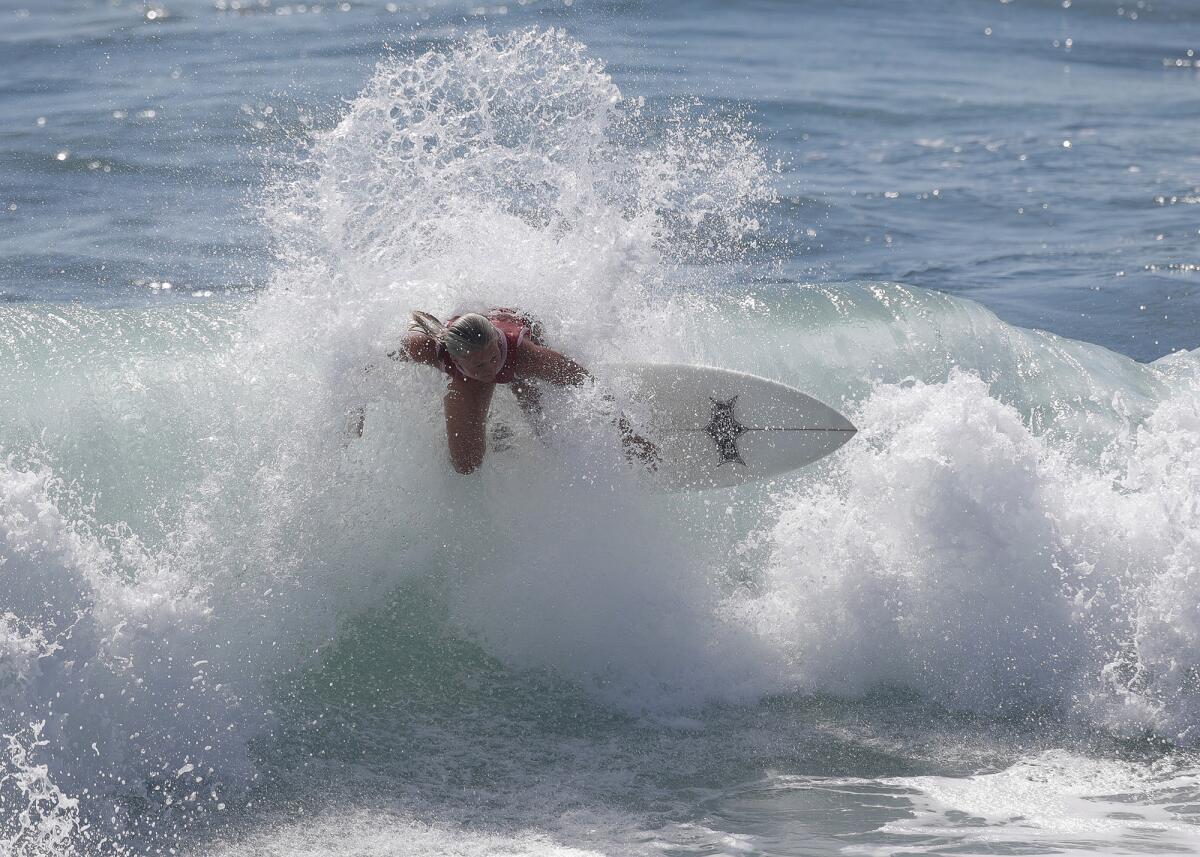 Scout Mitchell goes off the top of a wave backside as she surfs toward first place in the girls' 16-and-over division final.