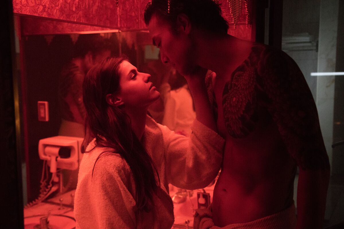 Hand to the flame: Alexandra Daddario and Takehiro Hira in "Lost Girls and Love Hotels."