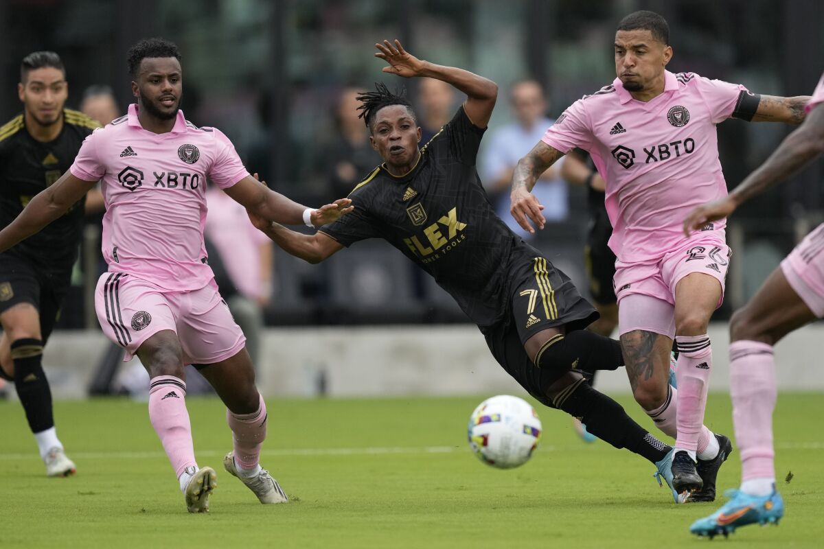 LAFC midfielder Latif Blessing makes a pass under pressure from Inter Miami midfielders Gregore Silva, right, and Mo Adams.