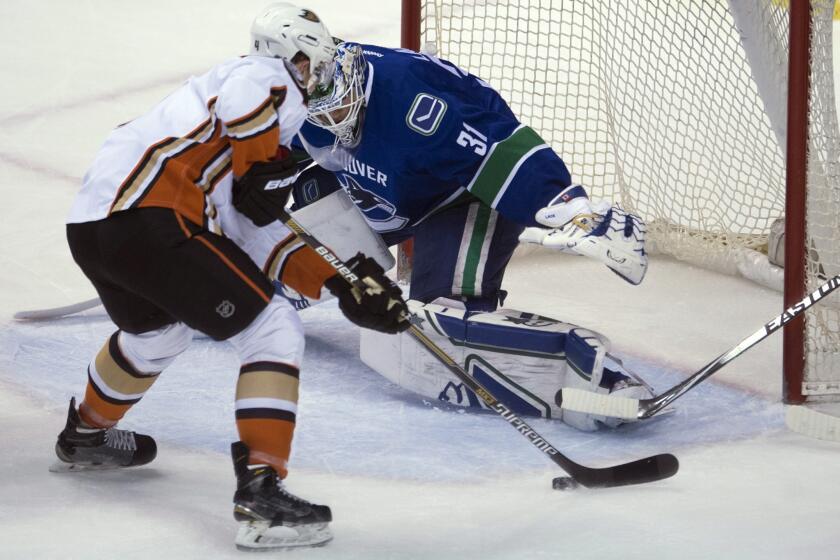 Defenseman Cam Fowler tries to shoot past Canucks goalie Eddie Lack during the first period of a game Monday in Vancouver. The Ducks lost to the Canucks, 2-1.
