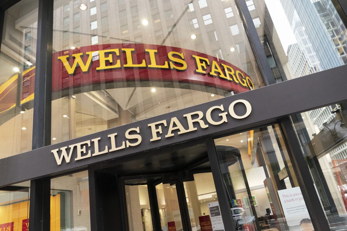 FILE - A Wells Fargo office is shown, Wednesday, Jan. 13, 2021 in New York. Four big banks reported noticeable declines in their first quarter profits on Thursday, April 14, 2022 as the volatile markets and war in Ukraine caused dealmaking to dry up and a slowdown in the housing market caused the mortgage market to slow. The results from Citigroup, Goldman Sachs, Morgan Stanley and Wells Fargo were similar to the results out of JPMorgan Chase, which on Wednesday reported a double-digit decline in profits for similar reasons.(AP Photo/Mark Lennihan, File)