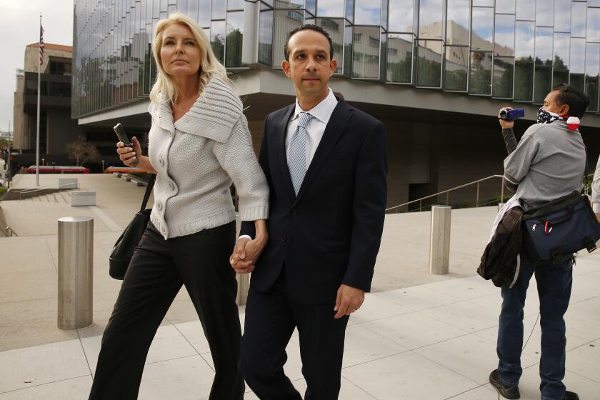 LOS ANGELES, CA - MARCH 12, 2020 Former Los Angeles city councilman Mitchell "Mitch" Englander, walks with his wife Jayne Englander, left, and his lead attorney Janet Levine, right, as they exit the Load Angeles Federal Courthouse after her appeared for a trial-setting conference Thursday morning March 12, 2020. The former Los Angeles city councilman is accused of obstructing an investigation into his allegedly accepting gifts from a businessman during trips to Las Vegas and Palm Springs and he faces seven federal criminal counts -- three of witness tampering, three for allegedly making false statements and a single count of scheming to falsify facts. (Al Seib / Los Angeles Times)