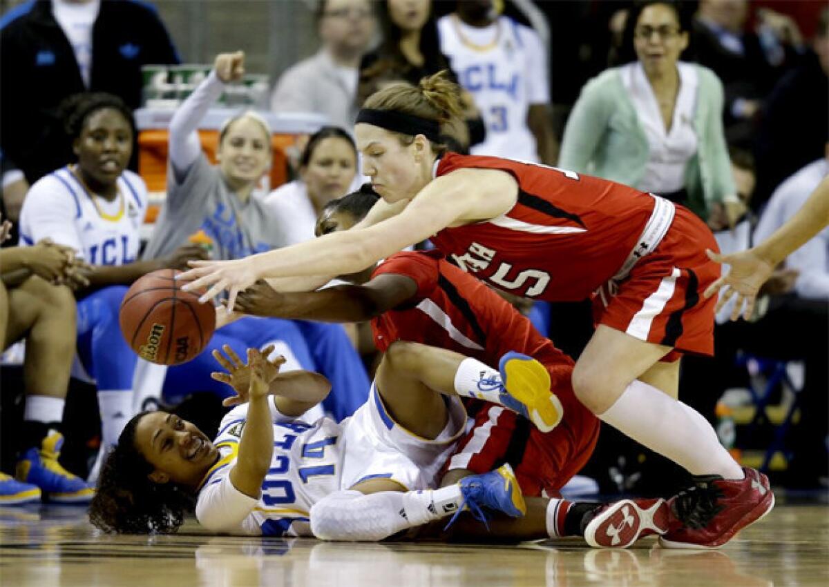 UCLA's Mariah Williams (14) battles for a loose ball with Utah's Michelle Plouffe.