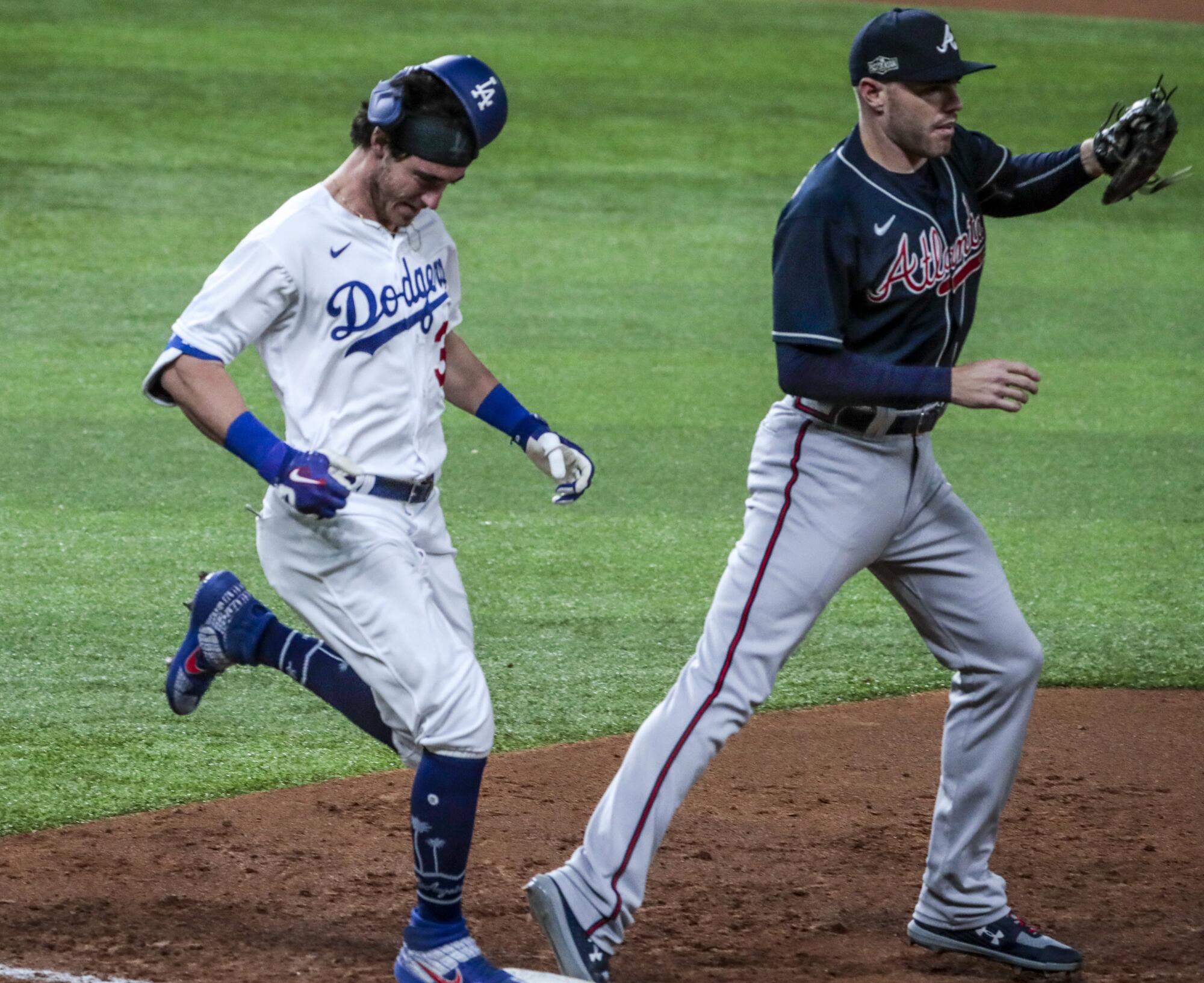 Dodgers' Cody Bellinger can't beat out the throw to Atlanta Braves first baseman Freddie Freeman during Game 1 of the NLCS.