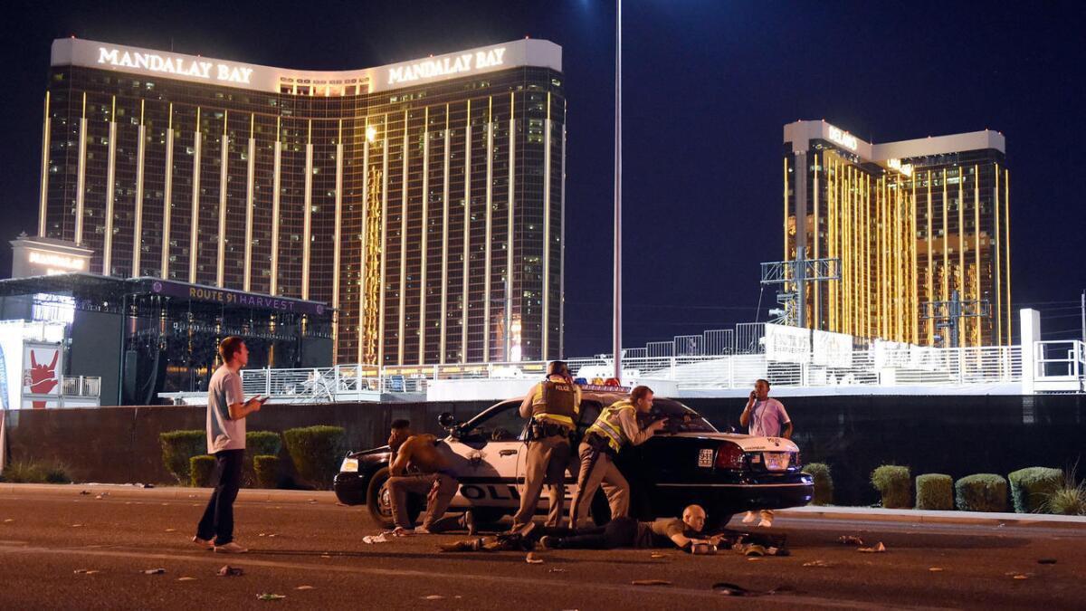 Las Vegas police work on a street outside the grounds of the Route 91 Harvest country music festival in Las Vegas on Sunday night.