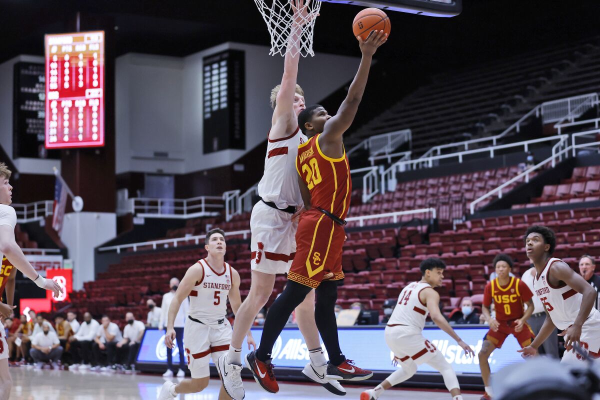 Stanford forward James Keefe (22) defends as Southern California guard Ethan Anderson (20) aims for the basket during the first half of an NCAA college basketball game Tuesday, Jan. 11, 2022, in Stanford, Calif. (AP Photo/Josie Lepe)