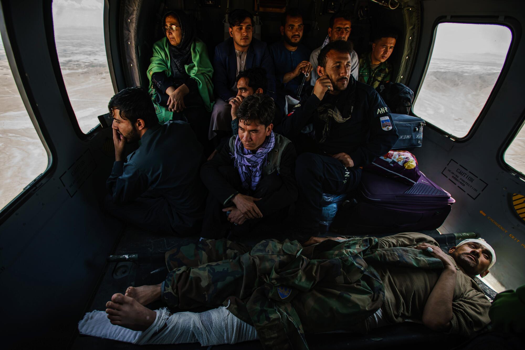 Hosy Andar, deputy governor of Ghazni province, top left, and soldiers are transported to Kabul Airbase