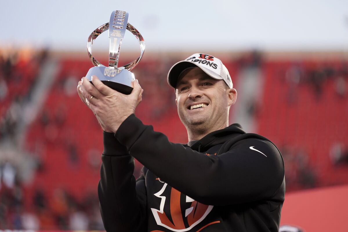 Bengals coach Zac Taylor holds the Lamar Hunt Trophy given to the AFC champion.