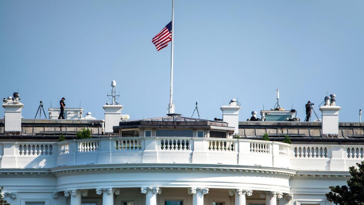 The U.S. flag flies at half-staff over the White House on Sunday. It was raised Monday.
