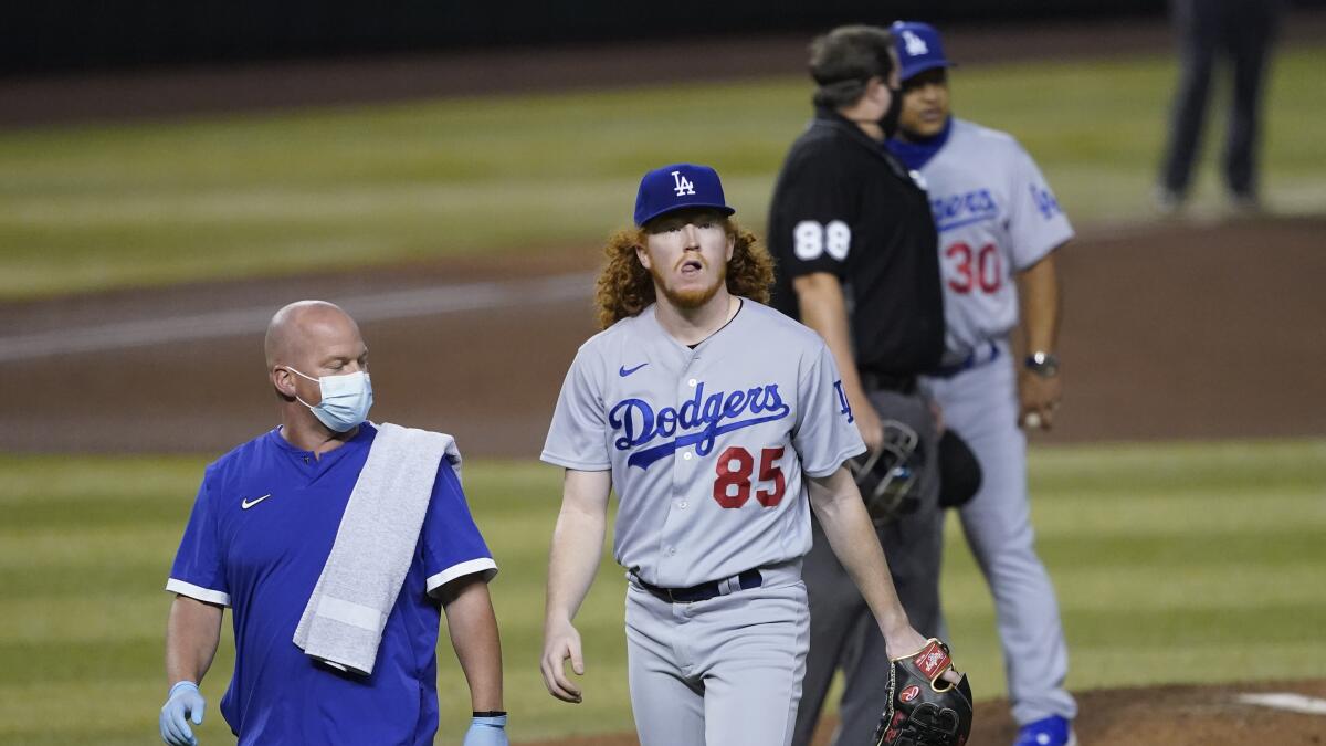 Los Angeles Dodgers' Dustin May takes liner off head during game