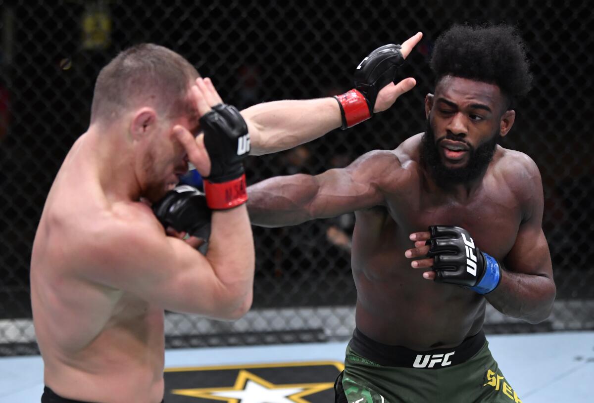 LAS VEGAS, NEVADA - MARCH 06: (R-L) Aljamain Sterling punches Petr Yan.