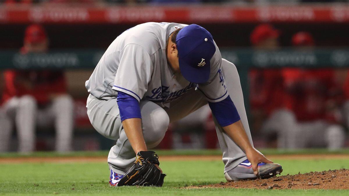 Dodgers pitcher Hyun-Jin Ryu holds his left foot after it was hit by a batted ball against the Angels on June 28.