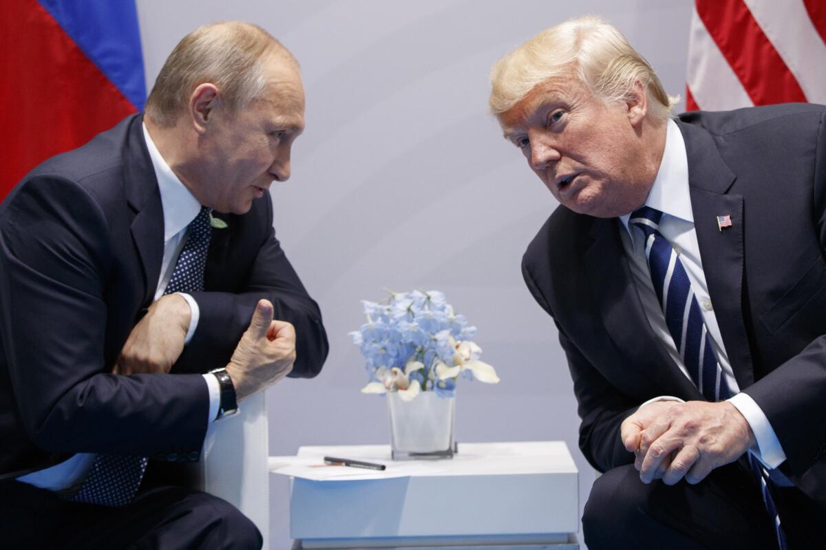 President Trump and Vladimir Putin lean in as they chat at the 2017 G-20 summit.