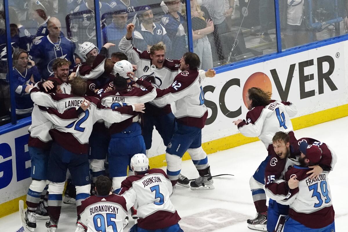 Colorado Avalanche players celebrate immediately after their Stanley Cup win over the Tampa Bay Lightning on Sunday.