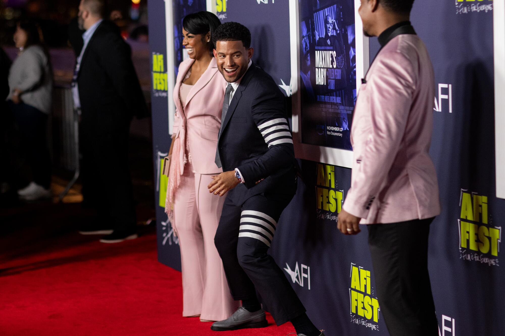 Armani Ortiz, co-director, greets Jasmine K. White, left and Asante White on the red carpet.