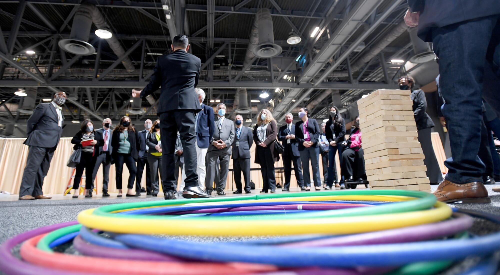 Mayor Robert Garcia speaks in front of officials, with hula hoops shown in the foreground