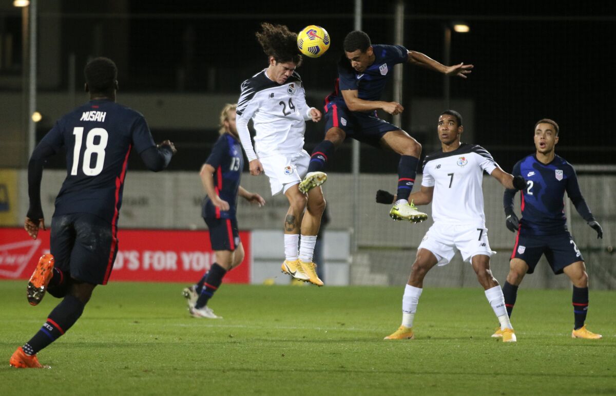 Panama's Juan David Tejada, left, and United States' Tyler Adams leap to head the ball during Monday's match.