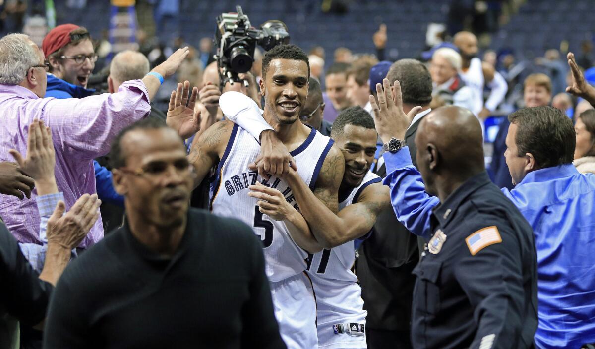 Memphis guard Courtney Lee (5) leaves the court with teammate Mike Conley after scoring the game-winning basket Thursday against the Sacramento Kings with less than one second remaining.
