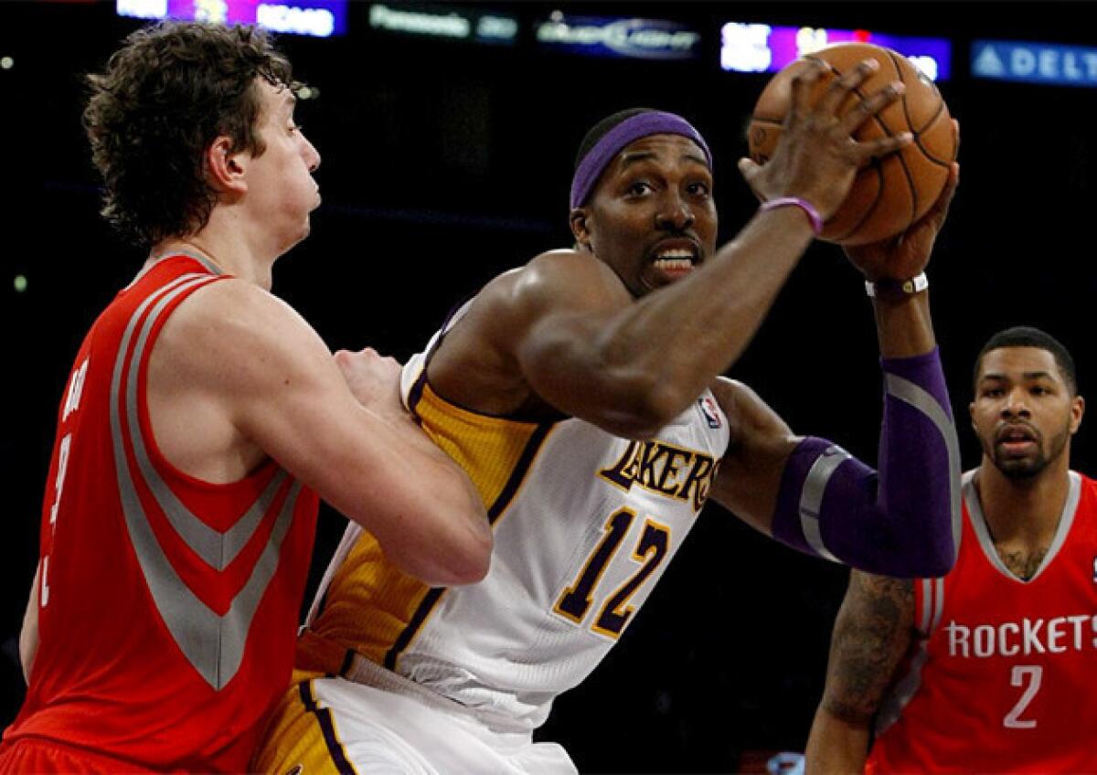 Lakers center Dwight Howard, middle, and Houston Rockets center Omer Asik, left, will be the key matchup in regular-season finale.