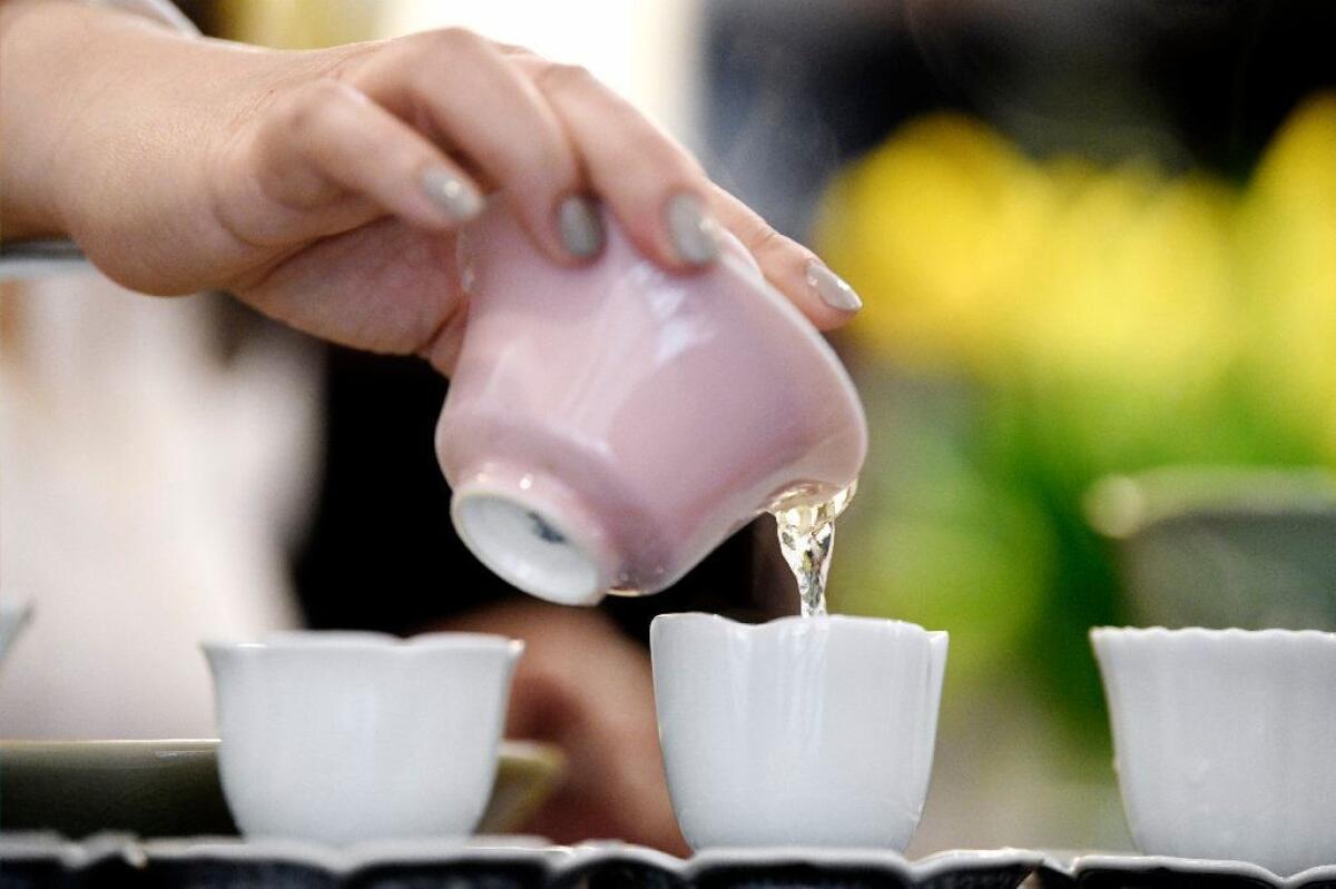 Imen Shan pouring tea from her favorite pink gaiwan.