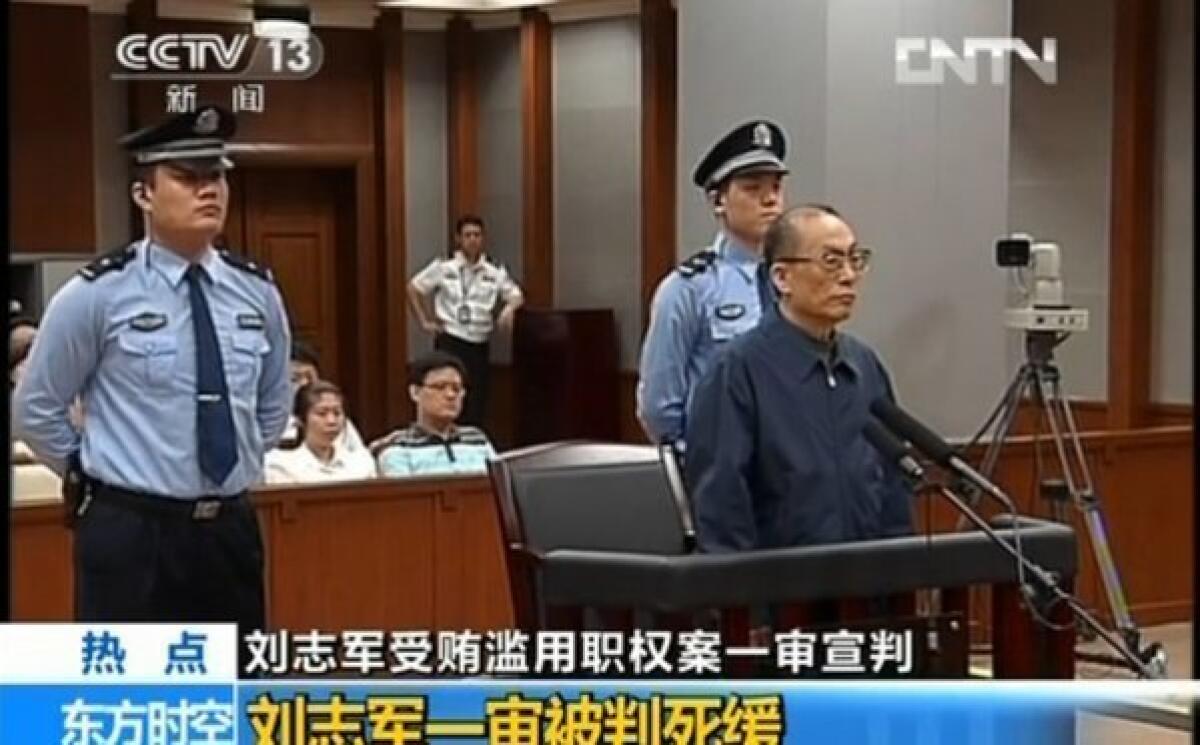 In a previous corruption case tied to China's railroad system, this screen grab taken from CCTV footage in shows former Railroad Minister Liu Zhijun, right, standing trial in Beijing.