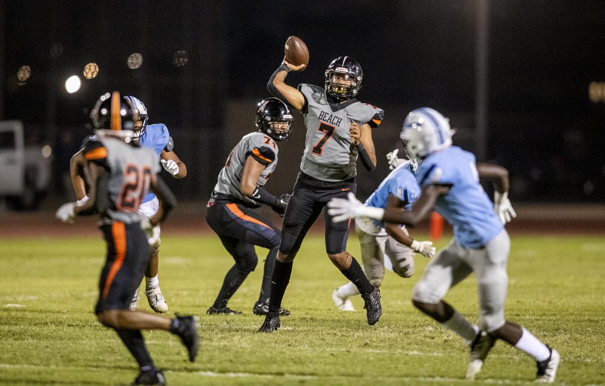 Huntington Beach's Daunte Bell throws a pass in a season opener against Mayfair on Friday.