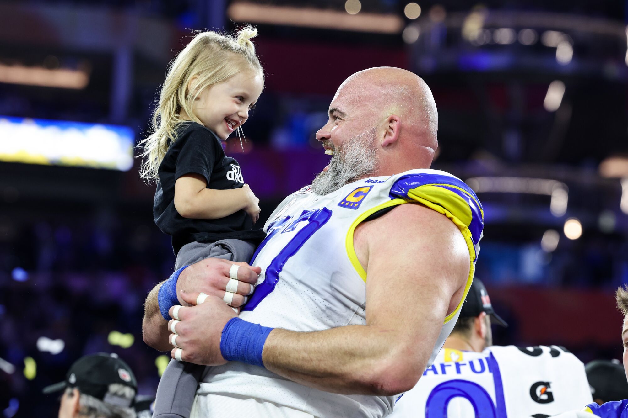  Rams offensive tackle Andrew Whitworth  holds the daughter of Matthew Stafford.