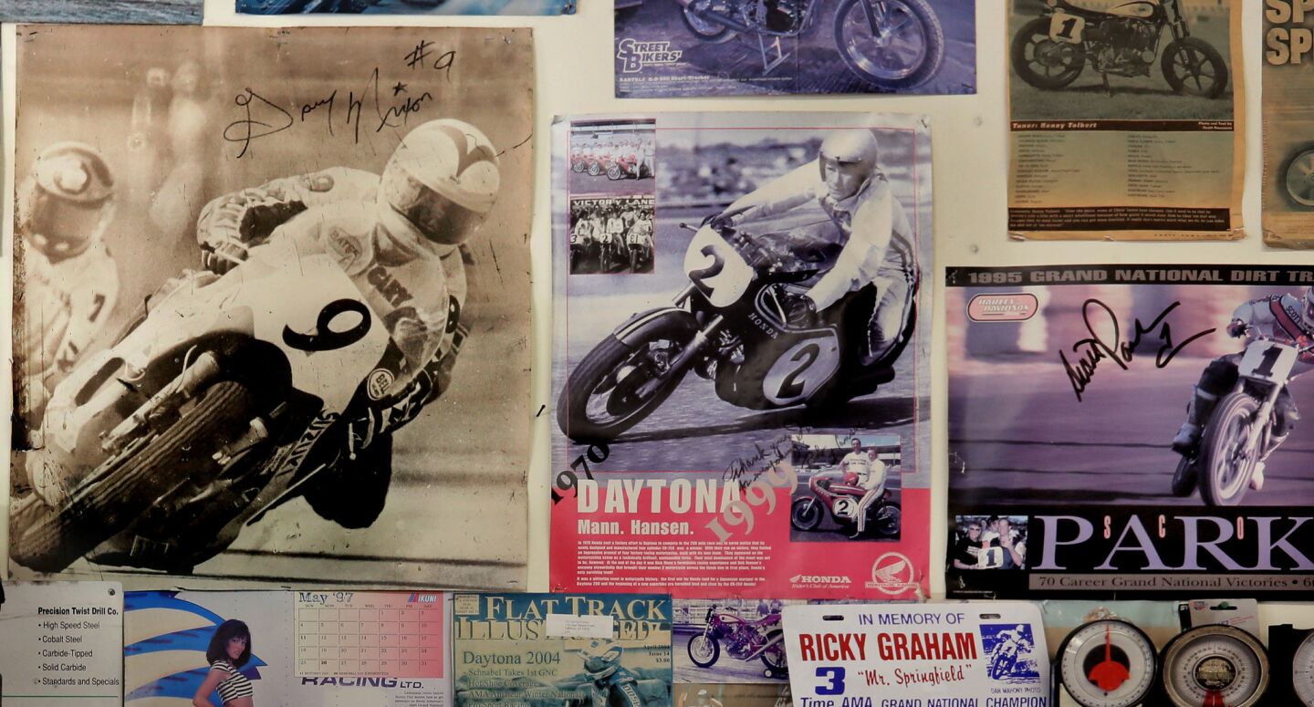 Autographed photos of motorcycle racers riding on frames designed by frame fabricator Jeff Cole cover the walls of Cole's garage in Fallbrook.