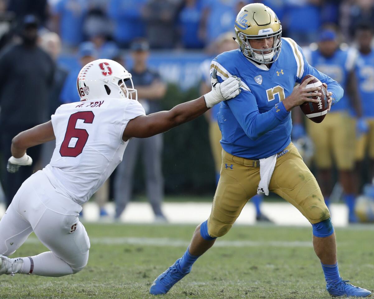 UCLA quarterback Wilton Speight gets pressured by Stanford defender Andres Fox during the fourth quarter.