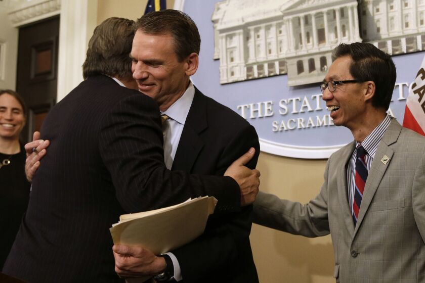 State Sen. Bob Hertzberg, D-Van Nuys, left, and Assemblyman Ed Chau, D-Arcadia, right, celebrate with Alastair Mactaggart, center, after the Legislature approved their data privacy bill Thursday, June 28, 2018, in Sacramento, Calif. Mactaggert removed a similar initiative he sponsored from the November ballot because the bill was passed. (AP Photo/Rich Pedroncelli)