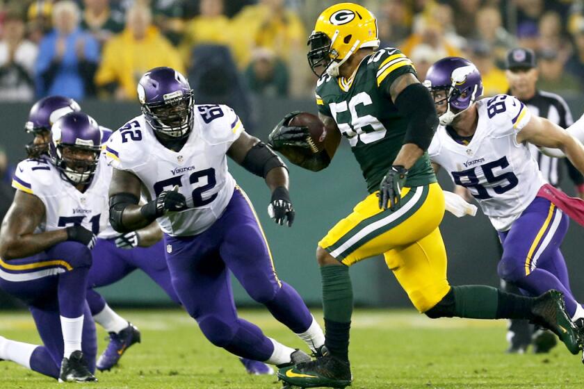 Packers outside linebacker Julius Peppers runs back an interception 49 yards for a touchdown against the Vikings.