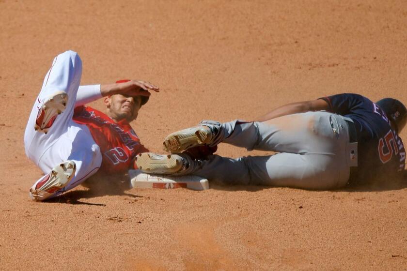 Minnesota Twins' Eduardo Escobar, right, lies on the ground after colliding with Los Angeles Angels shortstop Andrelton Simmons while stealing second base during the ninth inning of a baseball game, Sunday, June 4, 2017, in Anaheim, Calif. Both players were injured on the play but stayed in the game. (AP Photo/Mark J. Terrill)