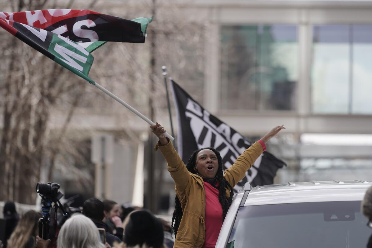 A woman waves a Black Lives Matter flag