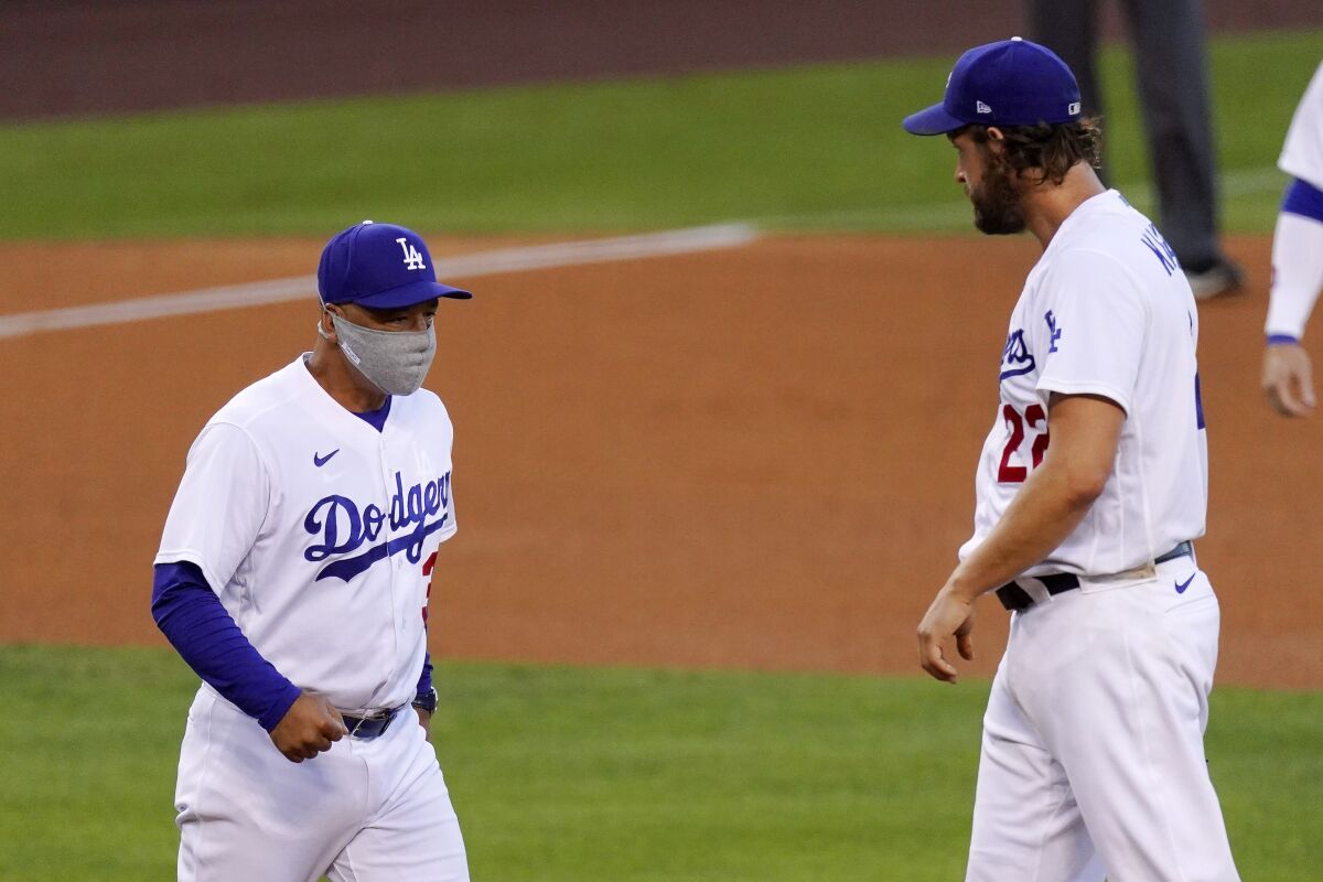 Dodgers starter Clayton Kershaw is taken out of the game by manager Dave Roberts during the fifth inning Aug. 8, 2020.