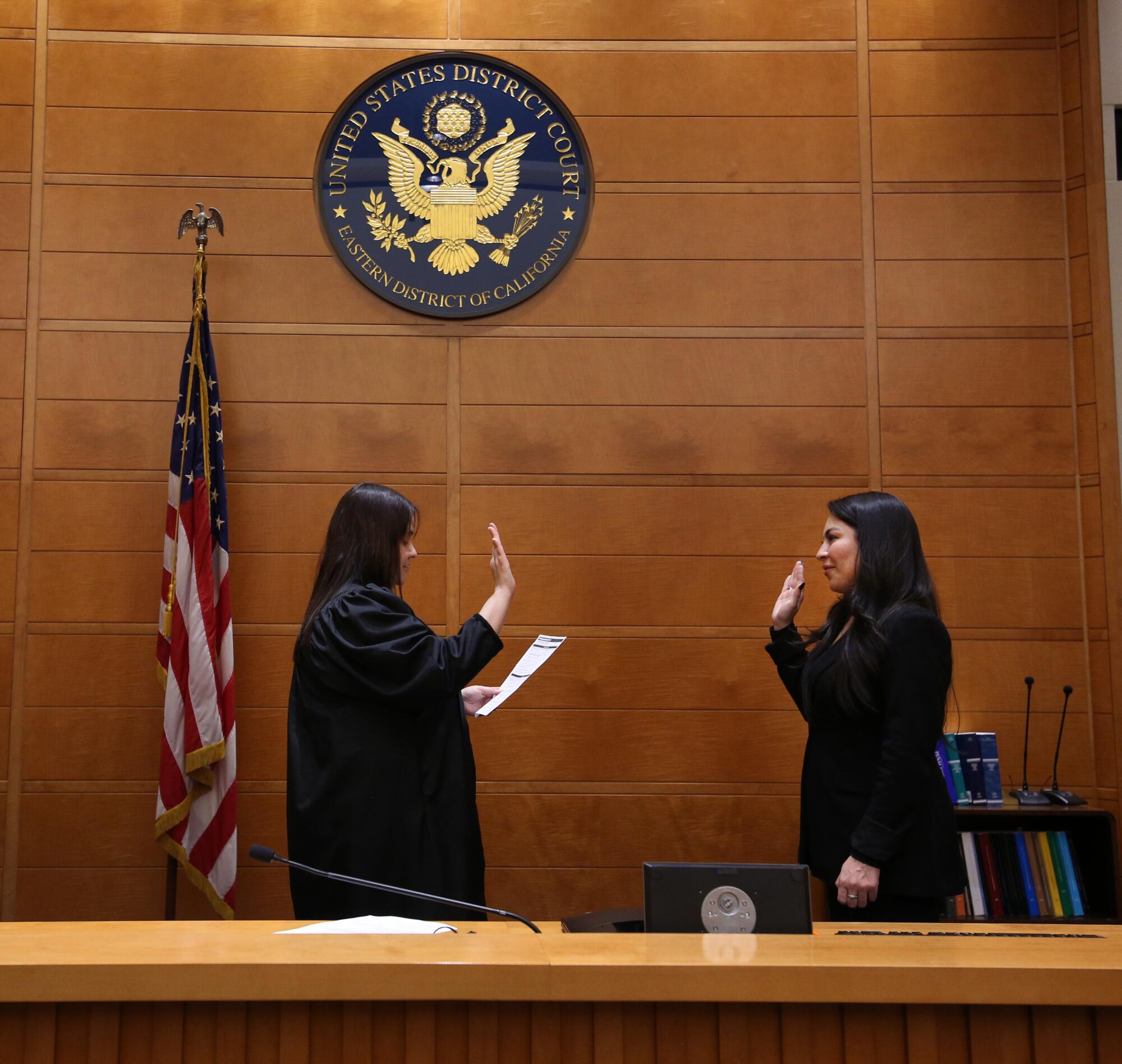 Jessenia Nunez, right, is sworn in at the Robert E. Coyle Federal Courthouse by Ana De Alba, who serves as United States ci