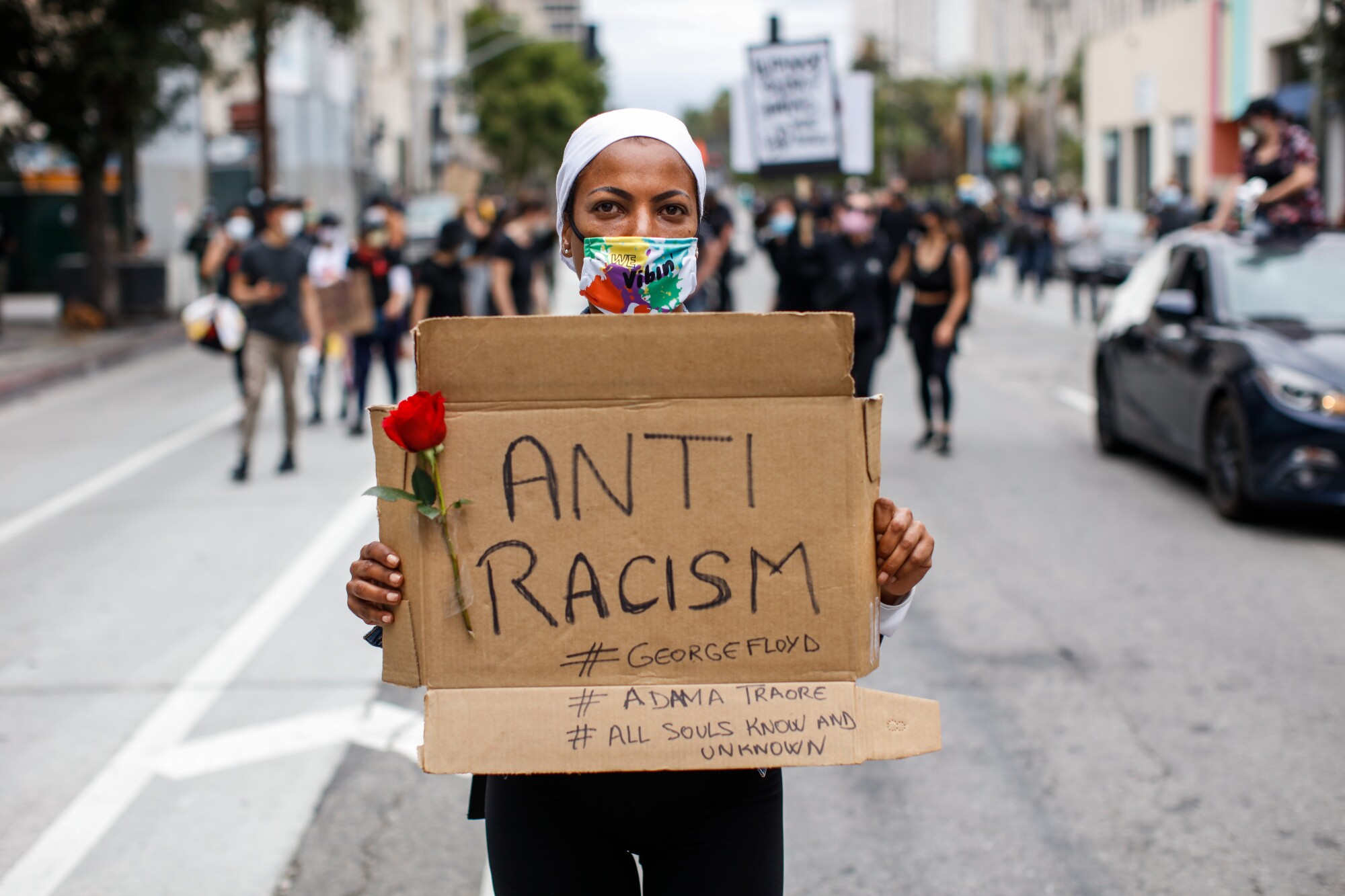 Katyana DeCampos, a citizen of France visiting California, marched with a sign with the words "Anti Racism" in downtown L.A.
