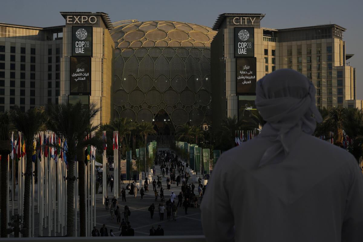 A man looks out at a dome-shaped structure in Dubai.